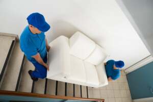 Movers carrying a sofa